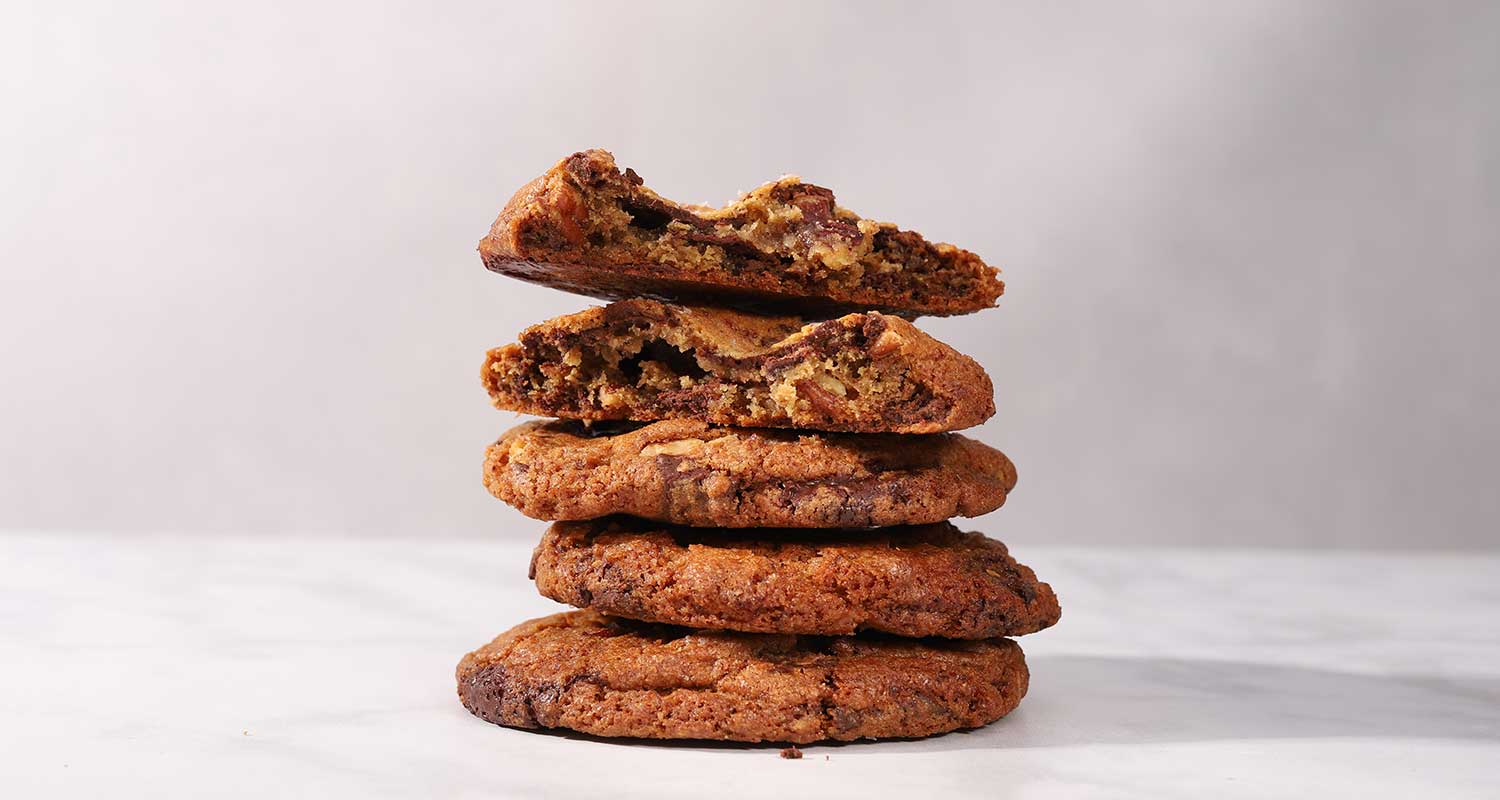 stacked sea salt chocolate pecan cookies with half